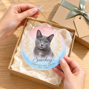 Hands unwrapping the Angel Wings Cat Portrait Suncatcher from a kraft gift box
