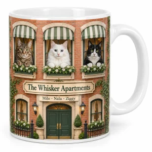 Mug with multiple cats – Cat Apartment Multi-Cat Mug with three cats together: a brown tabby, a white Turkish Angora and a black-and-white tuxedo and the text "The Whisker Apartments", "Milo · Nala · Ziggy", product photo on a white background