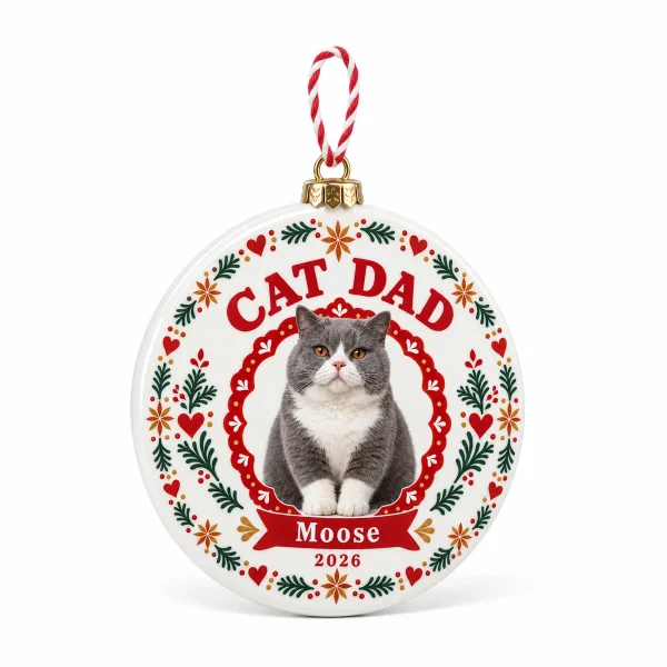Cat dad christmas ornament – Cat Dad Scandinavian Folk Christmas Ornament with a big gray-and-white British Shorthair and the text "CAT DAD", "Moose", "2026", product photo on a white background