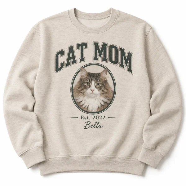 Cat mom sweatshirt – Cat Mom Varsity Sweatshirt with a fluffy Norwegian Forest cat (brown tabby and the text "CAT MOM", "Est. 2022", "Bella", product photo on a white background