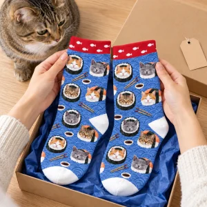 Hands unwrapping the Cat Sushi Roll Socks from a kraft gift box