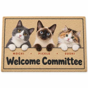 Custom cat welcome mat – Cat Welcome Committee Peeking Doormat with three cats: a gray-and-white tuxedo and the text "Welcome Committee", "Mochi · Pickle · Sushi", product photo on a white background