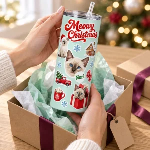 Hands unwrapping the Christmas Sticker Sheet Cat Tumbler from a kraft gift box