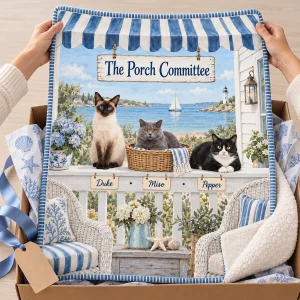 Hands unwrapping the Coastal Cottage Multi Cat Blanket from a kraft gift box