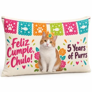 Cat birthday pillow – Papel Picado Cat Birthday Lumbar Pillow with an orange-and-white bicolor domestic shorthair and the text "Feliz Cumple, Chulo!", "5 Years of Purrs", product photo on a white background