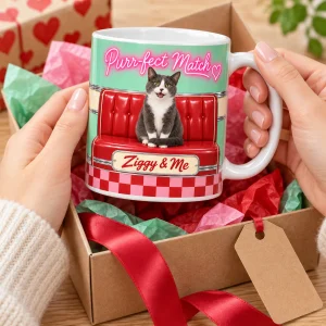Hands unwrapping the Retro Diner Valentine Cat Mug from a kraft gift box