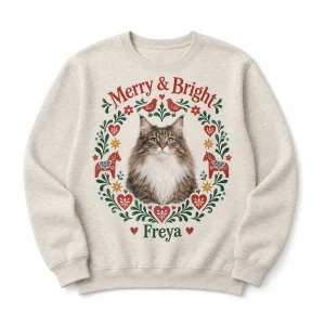 Custom christmas cat sweatshirt – Scandinavian Folk Christmas Cat Sweatshirt with a Norwegian Forest cat and the text "Merry & Bright", "Freya", product photo on a white background