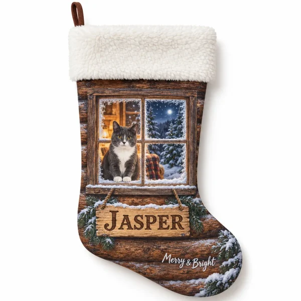 Personalized cat stockings for christmas – Snowy Cabin Window Cat Stocking with a gray-and-white tuxedo and the text "Jasper", "Merry & Bright", product photo on a white background